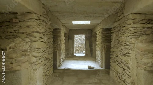 Camera forward push in back toward entrance door down long corridor inside the underground Tomb of Nefas Mawcha at the Northern Stelae Field in Aksum, Ethiopia
