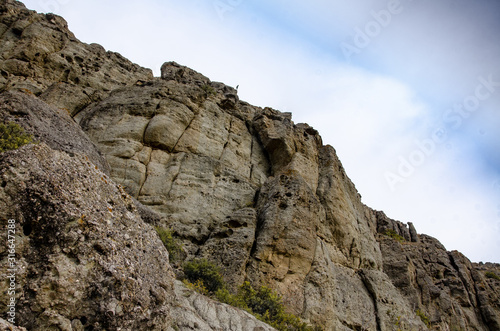Mountain landscape. Sheer cliff and sky. Travel and adventure.