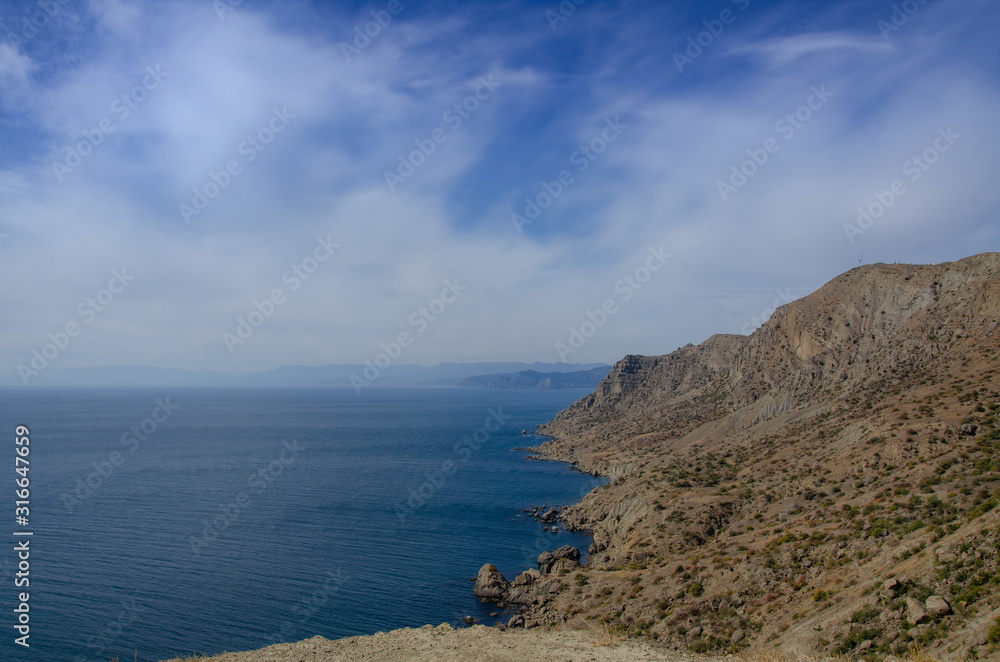 Sea and mountains. Seascape rocky coast. Sunny day.