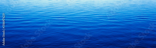 Fototapeta Naklejka Na Ścianę i Meble -  These are water reflections in Lake Tahoe. The water is a deep blue and the small ripples in the water form a pattern.