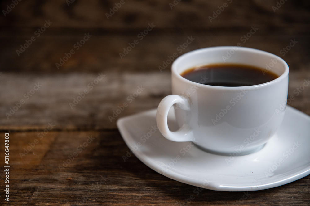 White cup of espresso coffee on a wooden background. White cup of espresso coffee on a wooden background.