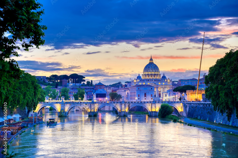A view along the Tiber River towards St. Peter's Basilica and the Vatican in Rome, Italy.