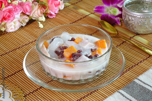 Dubo or Tubo, famous Phuket dessert. Made by cooking sweet potatoes, taro, red beans and droplets of tapioca flour in coconut milk with sugar palm syrup. Selective focus with copy space photo