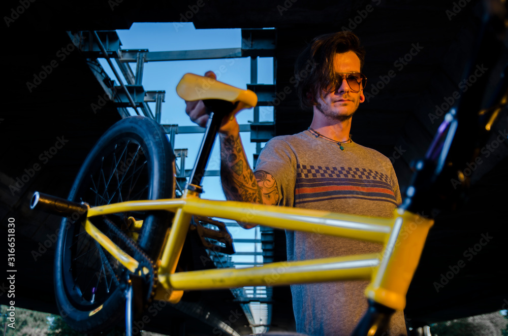 Urban man holding BMX bike 
