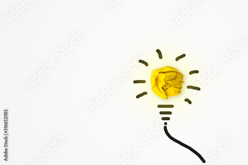 Business Creative Idea Concept : Yellow crumpled paper ball light bulb bright growing on white background.
