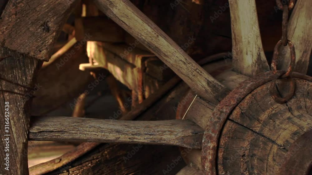 Close up detail view of wooden cart wheel and spokes. slow pan right Close up detail view of wooden cart wheel and spokes. slow pan right