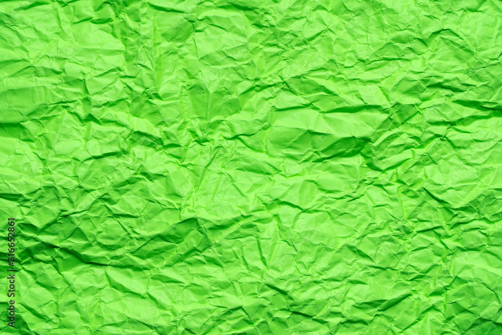 Green crumpled paper background or texture in detail Green crumpled paper background or texture in detail