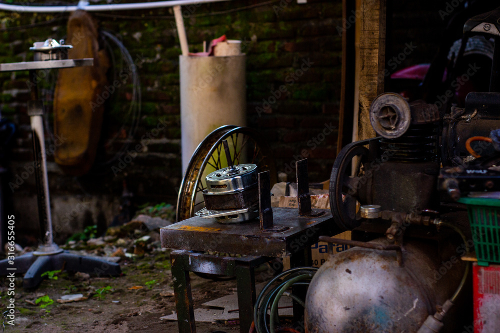 Rows of screws and main tools in an old motorcycle repair shop were repaired. Industrial scenes with blurred backgrounds and foreground equipment. Rows of screws and main tools in an old motorcycle repair shop were repaired. Industrial scenes with blurred backgrounds and foreground equipment.