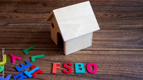 Property concept. FSBO text on wooden background. For sale by owner