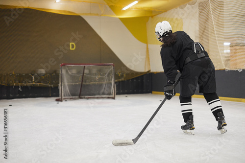 Photography Back view portrait of unrecognizable hockey player leading pluck during practice