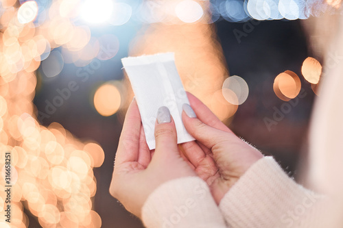 Hand warmers on night lights background.