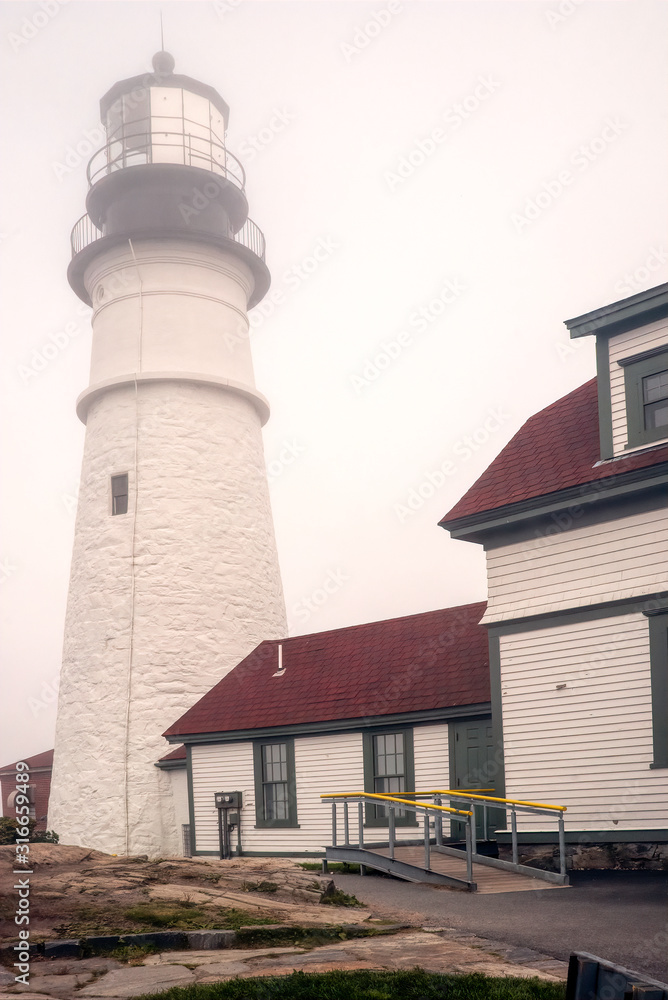 Close up of the Portland Head Lighthouse in dense fog. Close up of the Portland Head Lighthouse in dense fog.