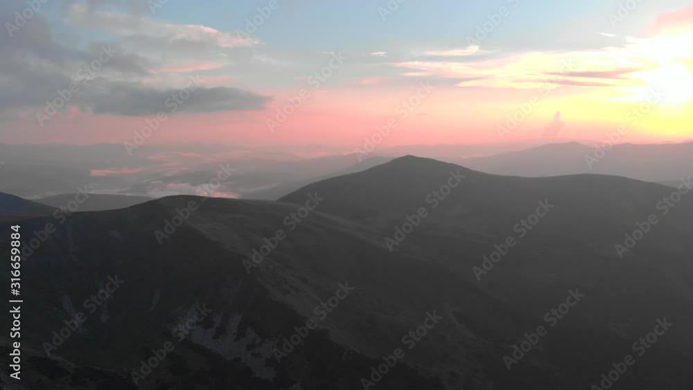Beautiful panorama of mountains peaks at sunset. Sunset sky with sunlight over mountains. Carpathians, Ukraine. Beautiful panorama of mountains peaks at sunset. Sunset sky with sunlight over mountains. Carpathians, Ukraine.
