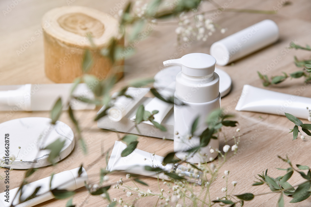 Cosmetic bottle containers packaging with green herbal leaves, Blank label for organic branding mock-up, Natural skincare beauty product concept. Cosmetic bottle containers packaging with green herbal leaves, Blank label for organic branding mock-up, Natural skincare beauty product concept.