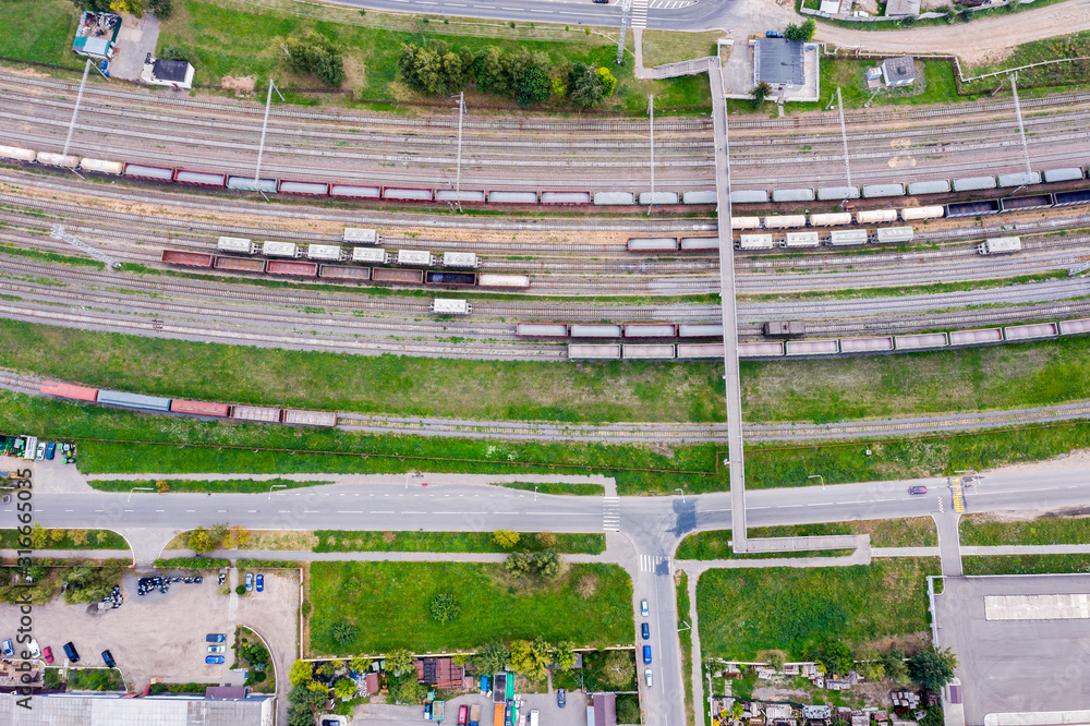 aerial top view of industrial railway station with freight wagons