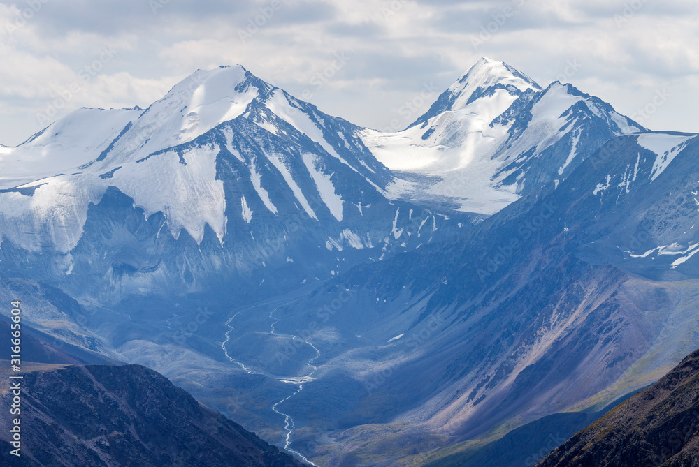 Mountain landscape. Snow-capped peaks, glaciers. Mountain climbing and mountaineering.