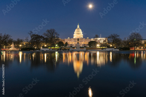 United States Capitol Building at twilight time with super full moon reflection with the big pool  Washington  DC  United States of America or USA  history and culture for travel concept