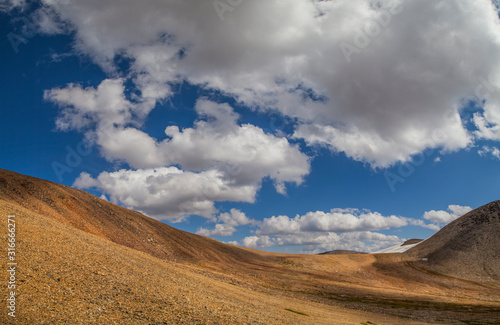 Desert hills and picturesque blue sky with white clouds