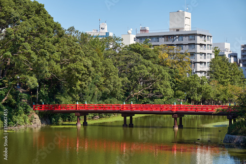 Red bridge over Kawazokoike Pond in Tennoji Park. Osaka. Japan