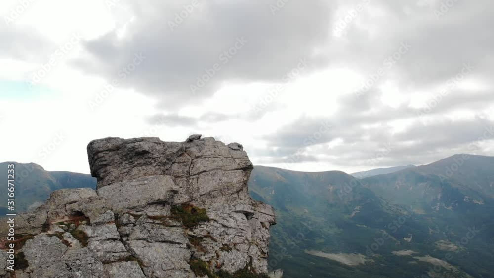 High rocky mountain peak. Beautiful summer landscape under the cloudy sky. Carpathians, Ukraine. High rocky mountain peak. Beautiful summer landscape under the cloudy sky. Carpathians, Ukraine.