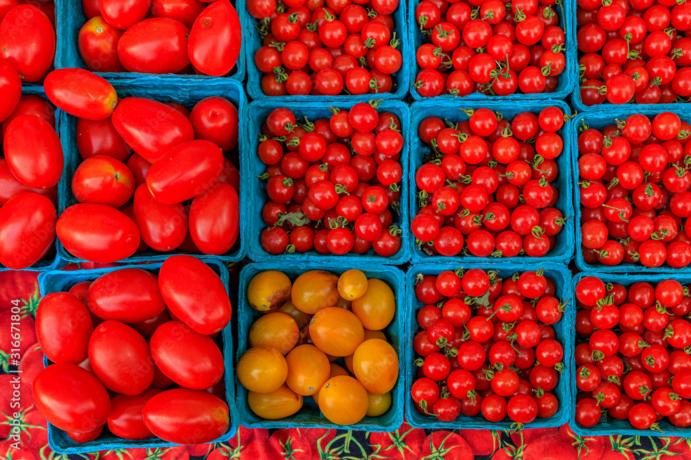 Selection of ripe red and yellow cherry and plum tomatoes at an outdoor farmers market in Manhattan, New York, USA Selection of ripe red and yellow cherry and plum tomatoes at an outdoor farmers market in Manhattan, New York, USA