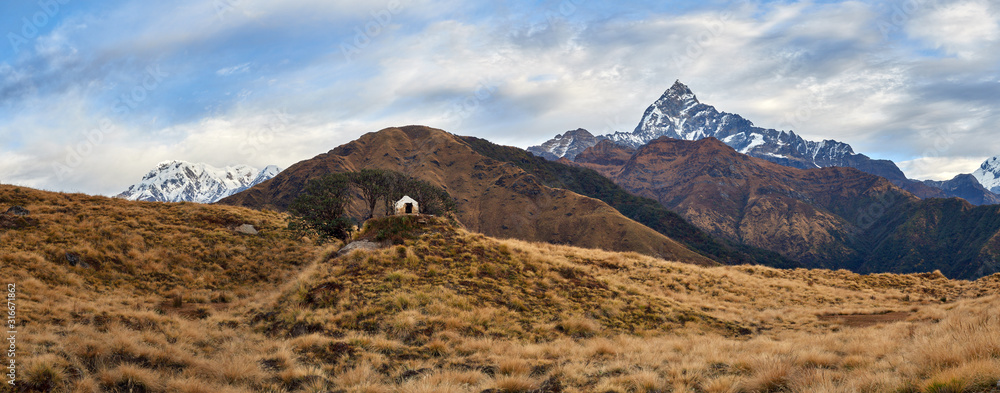 View of the small Hindu sanctuary against the background of the majestic Machapuchare and Mardi Himal. Nepal, the Himalayas.