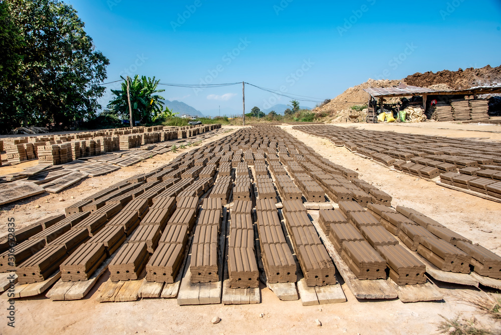 The production of ancient bricks in Thailand (the process of bringing bricks to dry in the sun)