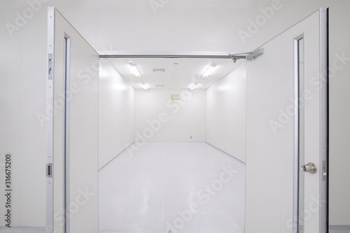 Perspective of empty warehouse store room with door open