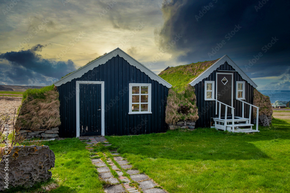 Typical view of turf-top houses in Icelandic countryside.