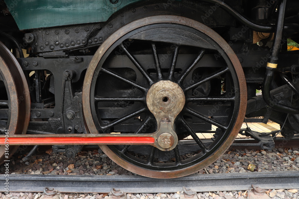 A close of view of the wheels of a vintage train. Retro wheel of the old train on the railway. 