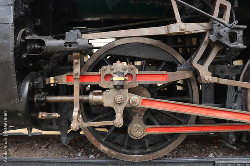 A close of view of the wheels of a vintage train. Retro wheel of the old train on the railway. 