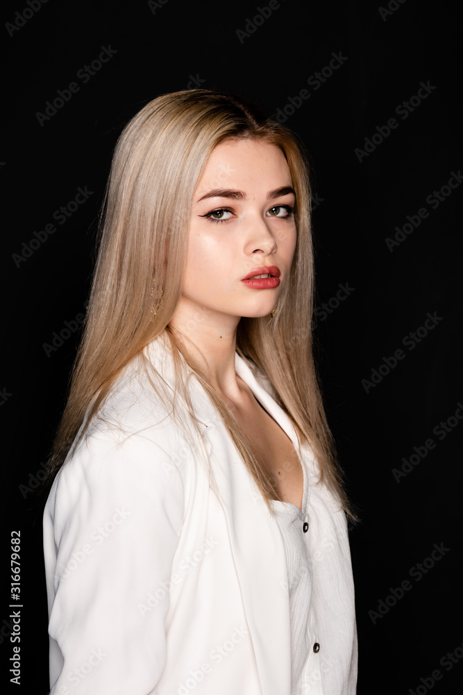 close up portrait of beautiful young model with blonde hair and black clothes, posing in photostudio on dark background close up portrait of beautiful young model with blonde hair and black clothes, posing in photostudio on dark background