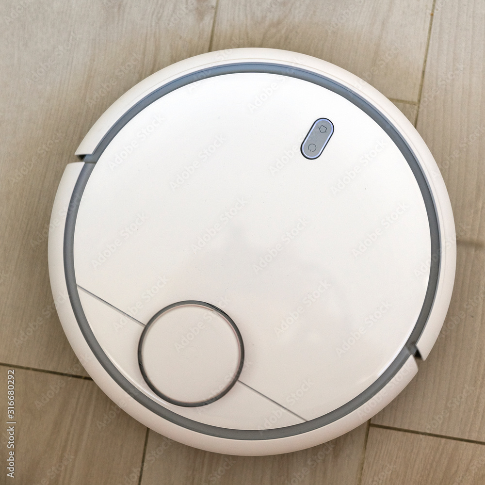 robot vacuum cleaner on wooden background robot vacuum cleaner on wooden background