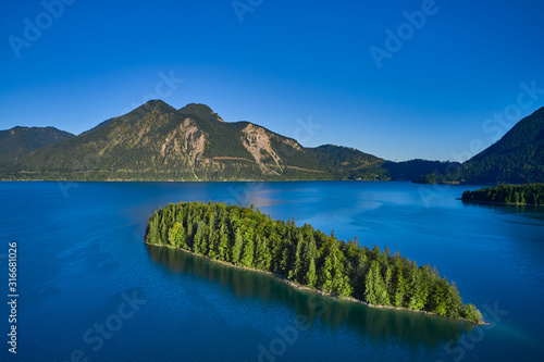 Sassau Island, Walchensee Lake, Germany. Clear blue sky, morning on the lake. Lake in Germany. Aerial view