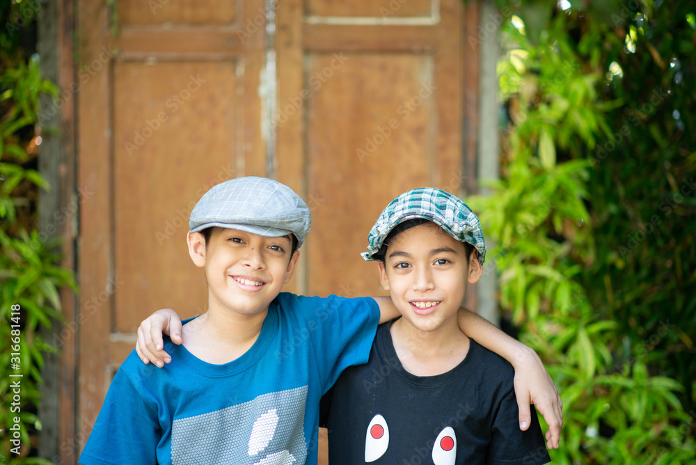 Little sibling handsome boy stand and smile together Little sibling handsome boy stand and smile together