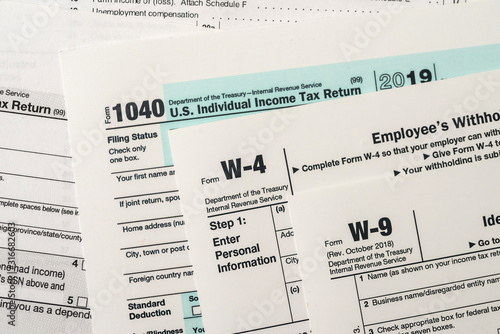 Paper blanks of 1040, w4 and w9 tax form close up