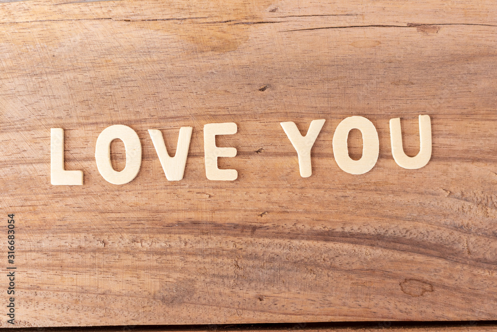 Love wooden text on board background.