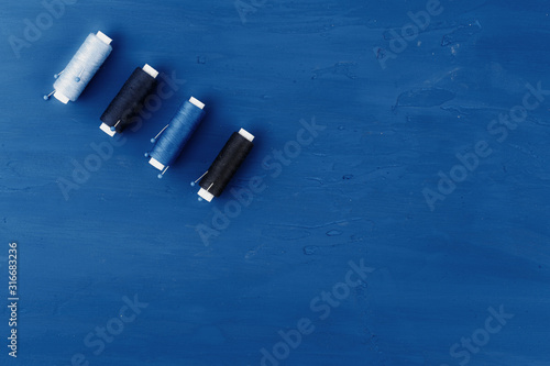 Tayloring accessories on classic blue background, top view photo