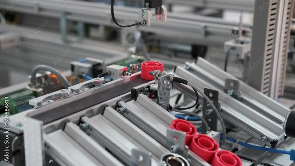 Close-up of product which automatically classified according to color in storage station. Handling and Sorting Application. Industry 4.0 concept; artificial intelligence in autonomous production. Close-up of product which automatically classified according to color in storage station. Handling and Sorting Application. Industry 4.0 concept; artificial intelligence in autonomous production.