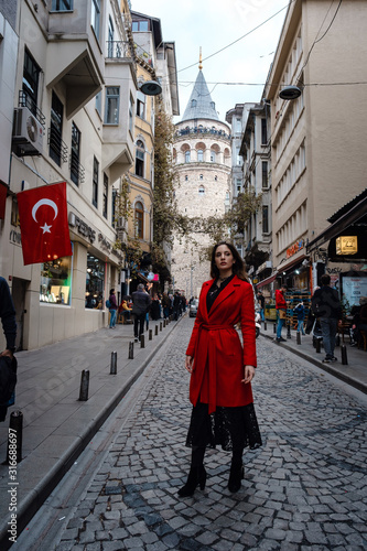 Portrait of beautiful woman with view of Galata tower in Istanbul, Turkey © YURII Seleznov