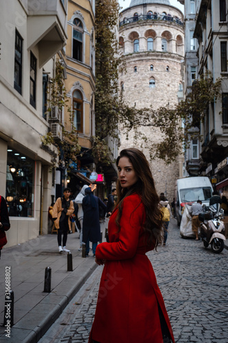 Portrait of beautiful woman with view of Galata tower in Istanbul, Turkey © YURII Seleznov