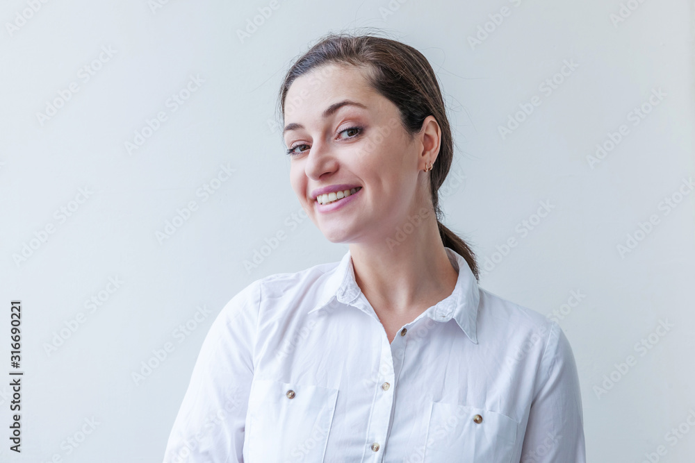 Happy girl smiling. Beauty portrait young happy positive laughing brunette woman on white background isolated. European woman. Positive human emotion facial expression body language Happy girl smiling. Beauty portrait young happy positive laughing brunette woman on white background isolated. European woman. Positive human emotion facial expression body language