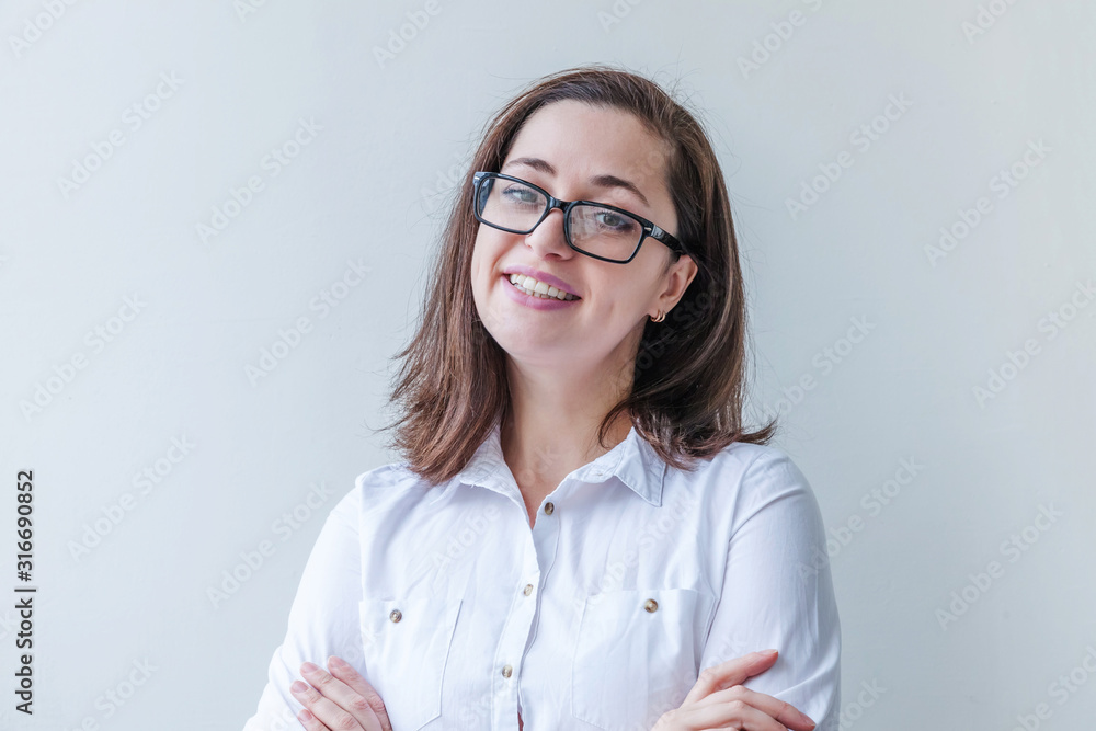 Beautiful happy girl smiling. Beauty simple portrait young smiling brunette woman in eyeglasses isolated on white background. Positive human emotion facial expression body language. Copy space Beautiful happy girl smiling. Beauty simple portrait young smiling brunette woman in eyeglasses isolated on white background. Positive human emotion facial expression body language. Copy space