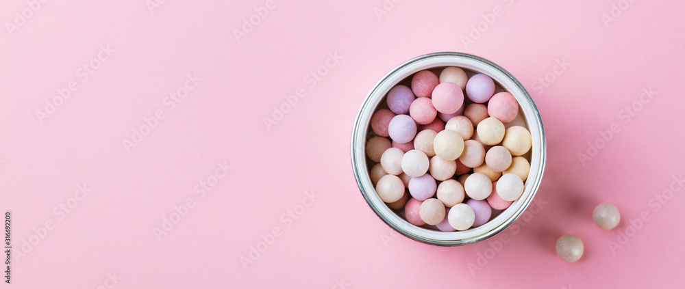 Pearl make up powder on pink pastel background. Top view. Copy space. Pearl make up powder on pink pastel background. Top view. Copy space.