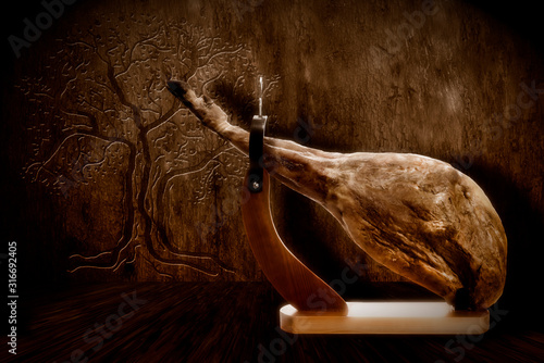 Whole Iberian ham leg extra quality on wooden background