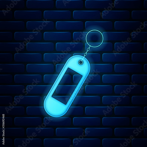 Glowing neon Key chain icon isolated on brick wall background. Blank rectangular keychain with ring and chain for key. Vector Illustration