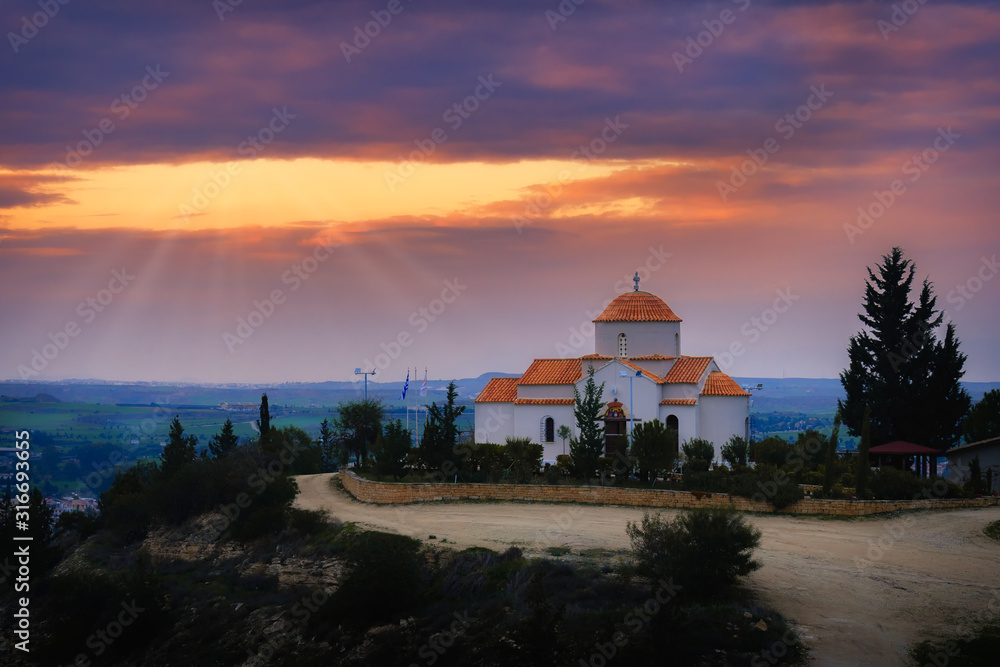 Panagia Tsampika orthodox church on top of a hill in Nicosia district, Cyprus on a sunset with light rays