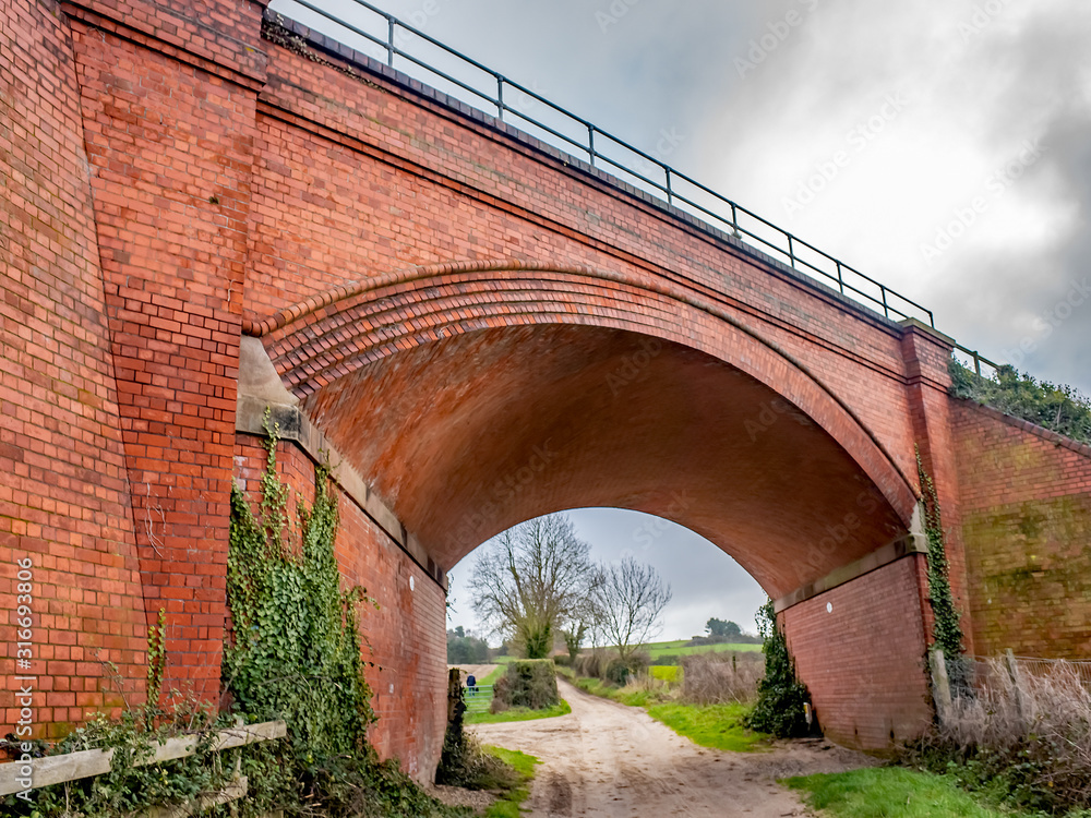  Red brick railway bridge over the public footpath in rural Norfolk