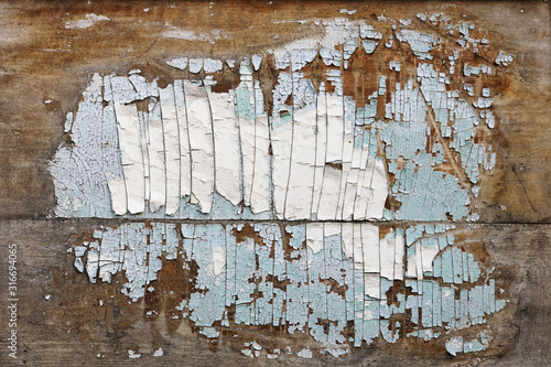 A stain of peeling old paint on a vintage wooden door looks like a map of the USA photo