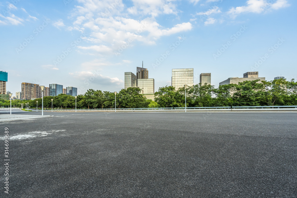 empty urban road with modern building in the city. - obrazy, fototapety, plakaty 